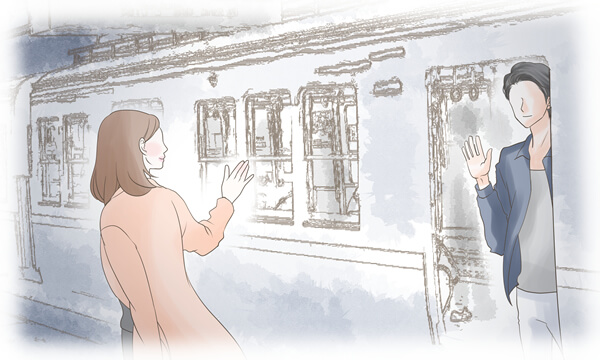 電車で別れる男女